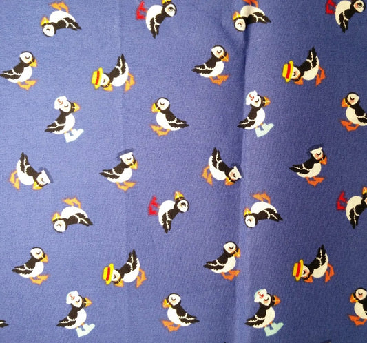 Puffins in hats on dark blue